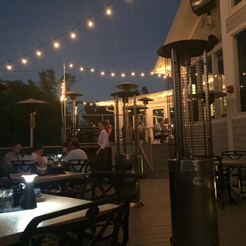 The Bay House - Pretty outdoor seating area overlooking river - Seafood Near Me - Naples, Florida