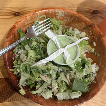 Zeke's - Greek pita rice bowl with bland sauce in the middle, straw trash making an X over the dressing - Acai Bowls Near Me - Chesapeake, Virginia
