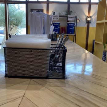 P Thai’s Khao Man Gai - Utensils, napkins, and igloo coolers containing water and lemon water. - Thai Near Me - Austin, Texas P Thai’s Khao Man Gai - Utensils, napkins, and igloo coolers containing water and lemon water. - Thai Near Me - Austin, Texas