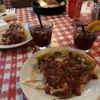 Gino's East - Magnificent Mile - Gino's Supreme with crumbled Italian sausage Deep Dish pizza and our carafe of sangria - Pizza Near Me - Chicago, Illinois Gino's East - Magnificent Mile - Gino's Supreme with crumbled Italian sausage Deep Dish pizza and our carafe of sangria - Pizza Near Me - Chicago, Illinois