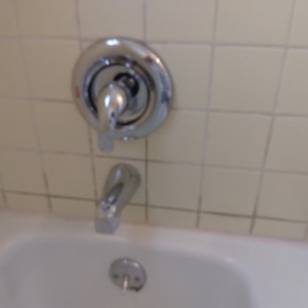 Surface Genie - Shows the strange material put in that doesn't seem like grout, and it's wrong color. - Grout Services Near Me