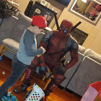 Deadpool Party Services - Deadpool helping to open gifts! - Party Characters Near Me Deadpool Party Services - Deadpool helping to open gifts! - Party Characters Near Me