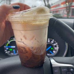 a hand holding a cup of coffee a hand holding a cup of coffee