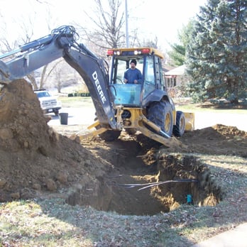 Frank's Trenching - Filling in the holes. Almost done, a little grass seed later and you couldn't even tell they were there. - Plumbing Near Me - Omaha, Nebraska