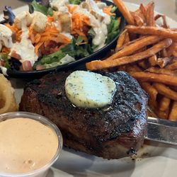 Montana's BBQ & Bar - 10 oz sirloin topped with garlic herb butter. Seasoned sweet potato fries & chipotle (mayo) dipping sauce. Good eats!