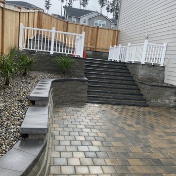 Pro Landscaping - a brick patio with steps leading up to the house - Landscaping Near Me - Tacoma, Washington