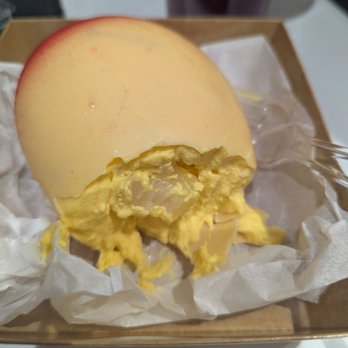 Moignet A Social Cafe - Mango mousse with pieces of mochi inside white chocolate shell. Run and get yours mmmm! - Bakeries Near Me - Las Vegas, Nevada Moignet A Social Cafe - Mango mousse with pieces of mochi inside white chocolate shell. Run and get yours mmmm! - Bakeries Near Me - Las Vegas, Nevada