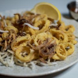 Flash fried calamari over crispy rice noodles, sweet chili garlic sauce on the side. Flash fried calamari over crispy rice noodles, sweet chili garlic sauce on the side.