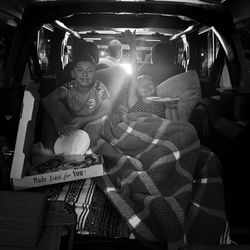 The kids set up in the back of the car watching