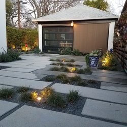 D L R Construction - Replaced old driveway with modern pavers, greenery, and lights--now a cozy, stylish spot for relaxing and entertaining.