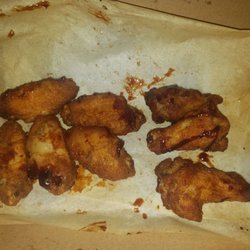 Domino's Pizza - Honey BBQ wings, half the sauce they put on is on the wrapper...maybe 10 drops? Small drops on small wings.