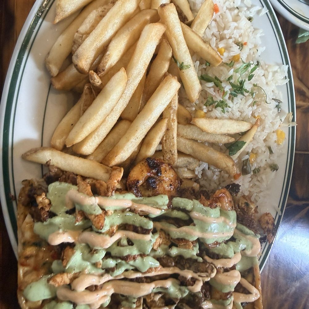 Egros tejanos it's chicken shrimp beef with white rice and black beans chipotle sauce cilantro sauce guacamole corn and side of fries
