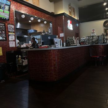 John The Baker - The front counter and you can see the pizza going and coming out of the oven - Pizza Near Me - Pembroke Pines, Florida