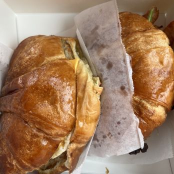 Knead Donuts & Tea - Left: sausage egg and cheese Right: bacon Bacon, Egg and Cheese Croissant Sandwich with spring mix - Donuts Near Me - Long Beach, California Knead Donuts & Tea - Left: sausage egg and cheese Right: bacon Bacon, Egg and Cheese Croissant Sandwich with spring mix - Donuts Near Me - Long Beach, California