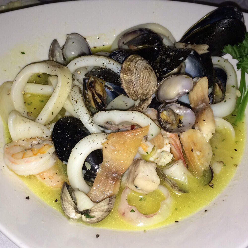 Donatello Restaurant - Zuppa di Pesce - seafood with white wine and tomato garlic sauce on a bed in fettuccine noodles - Italian Near Me - Toronto, Ontario