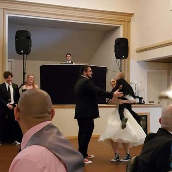 Fireside By The River - a bride and groom dancing at a wedding reception - American Near Me - Baldwinsville, New York Fireside By The River - a bride and groom dancing at a wedding reception - American Near Me - Baldwinsville, New York