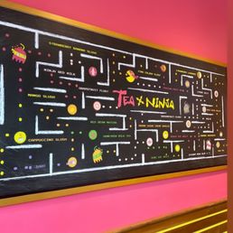 a blackboard in a pink room