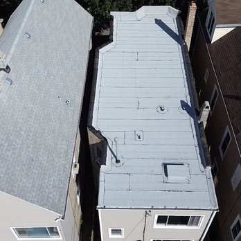 Perez Roofing & Masonry - Flat roof resurfacing in progress -- extending the life of the existing roof with a new protective roofing system. Perez Roofing & Masonry - Roofing Near Me Perez Roofing & Masonry - Flat roof resurfacing in progress -- extending the life of the existing roof with a new protective roofing system. Perez Roofing & Masonry - Roofing Near Me