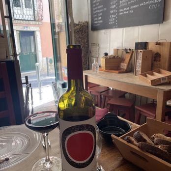 Alfama Cellar - Our table in the wine bar section of this little restaurant. You can see the entire menu on the wall. - Portuguese Near Me - Lisbon, 11