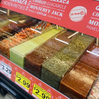 El Super - a display of spices in a grocery store - A refrigerated display case at El Super in Tucson, AZ, showcasing different types of Mexican salsas and food items, with signage in Spanish and prices. - Grocery Near Me - Tuscon, Arizona