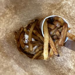 Burger at the bottom and the bag of fries. Burger at the bottom and the bag of fries.