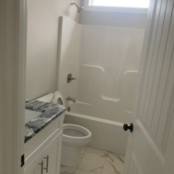 SMP Builders - a bathroom with a toilet, tub, and sink - General Contractors Near Me SMP Builders - a bathroom with a toilet, tub, and sink - General Contractors Near Me