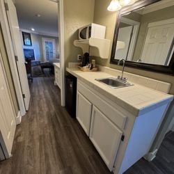 Cambria Pines Lodge - Small kitchenette with mini fridge and microwave and hot water kettle for coffee and tea.