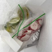 Photo of Tacos El Gordo - Chula Vista, CA, United States. Take out bag comes with salsa and radish
