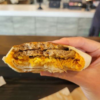 Taco Bell - Live Más Café - a hand holding a burrito - Fast Food Near Me - Chula Vista, California Taco Bell - Live Más Café - a hand holding a burrito - Fast Food Near Me - Chula Vista, California