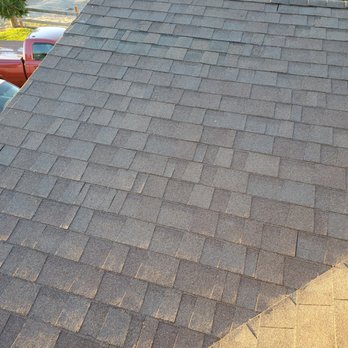 MacArthur Contractors - the roof of a house with a car parked in the driveway - Roofing Near Me MacArthur Contractors - the roof of a house with a car parked in the driveway - Roofing Near Me
