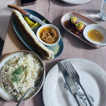 NAIA - Unappetizing chicken thigh. Side of oily rice and the spicy tuna crispy rice is in the back. - Mediterranean Near Me - Chicago, Illinois NAIA - Unappetizing chicken thigh. Side of oily rice and the spicy tuna crispy rice is in the back. - Mediterranean Near Me - Chicago, Illinois