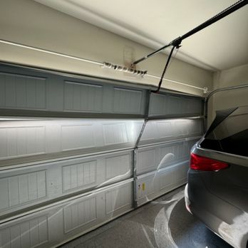 Cesar Garage Door Services - Damaged garage door before repair - Garage Door Services Near Me - Cedar Park, Texas