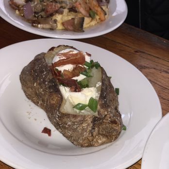 Hickory Tavern - Shrimp and Grits with baked potato - Sports Bars Near Me - Charlotte, North Carolina Hickory Tavern - Shrimp and Grits with baked potato - Sports Bars Near Me - Charlotte, North Carolina