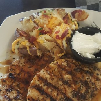 Fabiano's Corner Landing - Chicken in sauce with loaded baked potato - New American Near Me - Ionia, Michigan Fabiano's Corner Landing - Chicken in sauce with loaded baked potato - New American Near Me - Ionia, Michigan