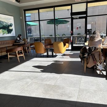 Starbucks - a woman sitting on a bench in a coffee shop - Coffee & Tea Near Me - Patchogue, New York