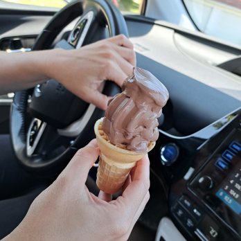 Village Creamery - a person holding an ice cream cone - Ice Cream & Frozen Yogurt Near Me - Brooklyn, Michigan Village Creamery - a person holding an ice cream cone - Ice Cream & Frozen Yogurt Near Me - Brooklyn, Michigan