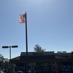 Herc Rental - Store front with torn flag