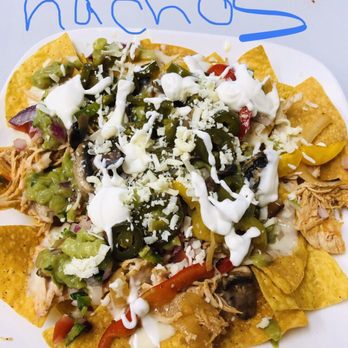 Sanchez Burrito - a plate of nachos on a table - Mexican Near Me - Little Falls, Minnesota Sanchez Burrito - a plate of nachos on a table - Mexican Near Me - Little Falls, Minnesota