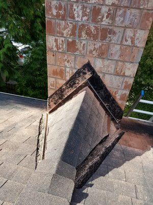 Mountain Goat Roofing - The new cricket roof. It prevents the buildup of debris behind the chimney. - Lynnwood, WA Mountain Goat Roofing - The new cricket roof. It prevents the buildup of debris behind the chimney. - Lynnwood, WA