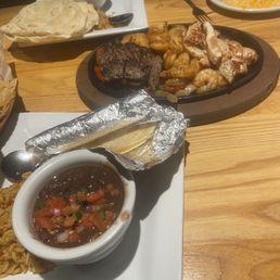 We each got rice and beans and four tortillas. This picture also shows the cast iron plate of our three proteins with peppers and onions