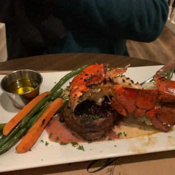 The Raintree Restaurant - Steak and lobster (after he'd cut into it already). Not prime, but still a lovely meal. - American Near Me - Saint Augustine, Florida