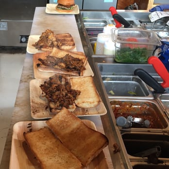 Perihelion Brewery - BBQ pork sandwiches hot off the grill and waiting to be finished. - Burgers Near Me - Seattle, Washington Perihelion Brewery - BBQ pork sandwiches hot off the grill and waiting to be finished. - Burgers Near Me - Seattle, Washington