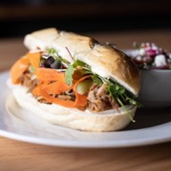 Home & Away - The Banh Mi - choice of chicken or pork, sesame glaze with pickled carrots, cucumber, cilantro and garlic aioli.