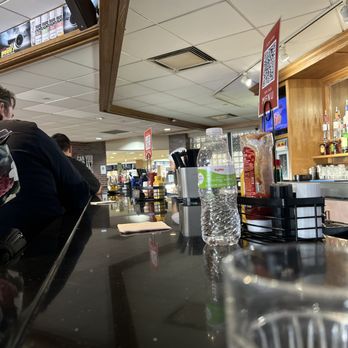 Pauli's Lounge - a man sitting at the bar - American Near Me - Omaha, Nebraska Pauli's Lounge - a man sitting at the bar - American Near Me - Omaha, Nebraska