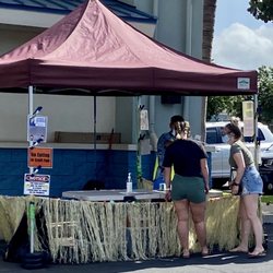Checking temperature of everyone entering swap meet area.