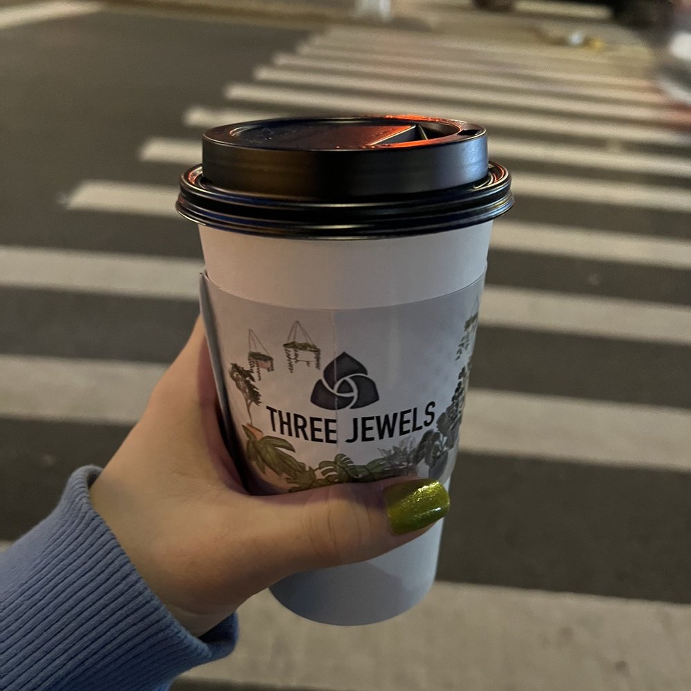 a hand holding a cup of coffee a hand holding a cup of coffee