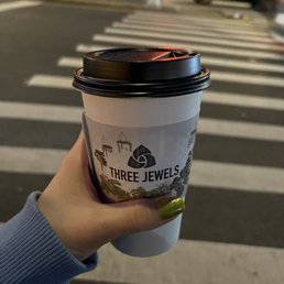 a hand holding a cup of coffee