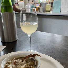 Chilled wine bottle in nice cooler; French 75 (yum!) cocktail, gumbo from Elysian Seafood.