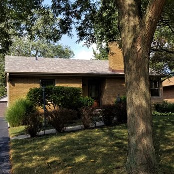 Davis Roofing & Construction - a house with a tree in the front yard - General Contractors Near Me - Addison, Illinois