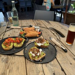DoceCuarenta - Avocado toast with cherry tomato, avocado toast with poached egg, and empanada trio